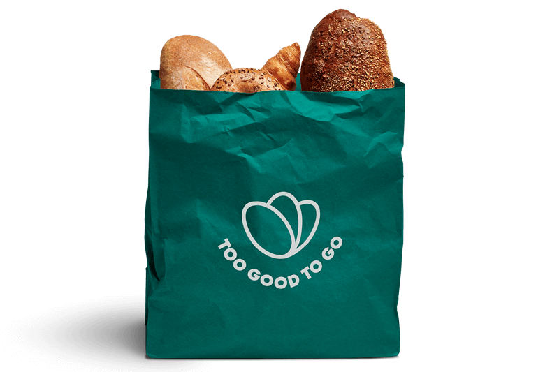 Eine grüne Tasche mit verschiedenen Broten. Auf der Tasche steht: Too Good To Go.